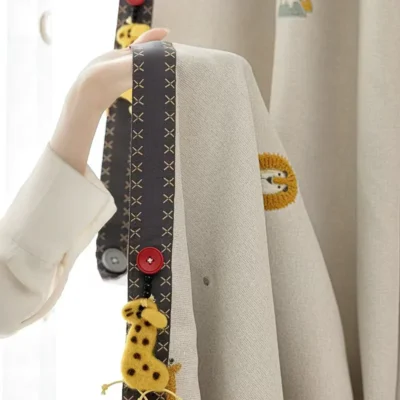 Measuring Forest King Curtain during installation – close-up of jacquard fabric and playful lion tieback