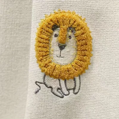 Fabric swatch of Forest King Curtain – beige jacquard with embroidered lion motif for kids’ rooms