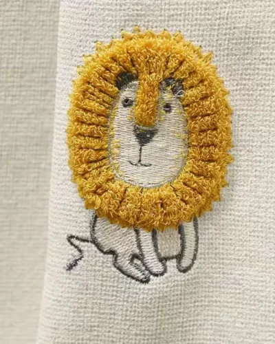 Fabric swatch of Forest King Curtain – beige jacquard with embroidered lion motif for kids’ rooms