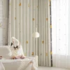 Forest King Curtain – embroidered lion motif on beige jacquard, styled in a cozy nursery with layered sheers