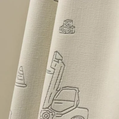 Close-up of Playful Construction Curtain fabric with jacquard forklift motif