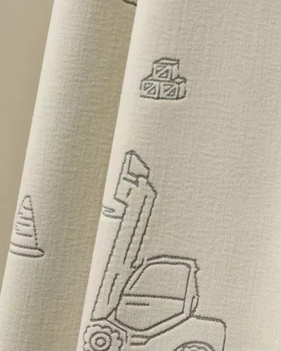 Close-up of Playful Construction Curtain fabric with jacquard forklift motif