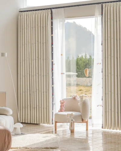 Children's room curtain with embroidered yellow planets and sheer white layers, ideal for playful and cozy spaces