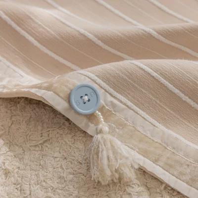 Close-up of Blush Sweet Curtain fabric showing striped jacquard texture with button detail.