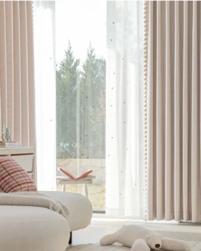 Soft mosaic jacquard curtain in pastel pink hanging in a cozy modern living room