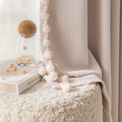 Pink mosaic jacquard curtain in kids' room with soft textures and decorative pom-pom trim