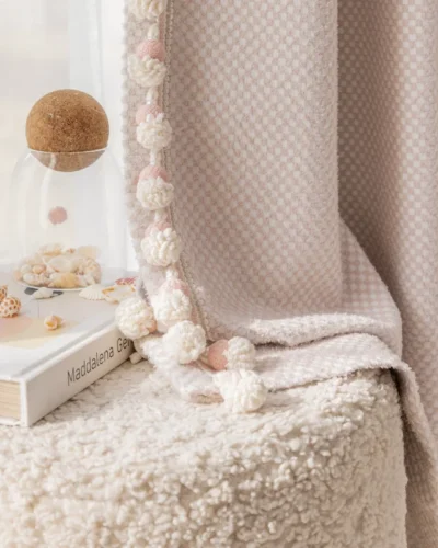Pink mosaic jacquard curtain in kids' room with soft textures and decorative pom-pom trim