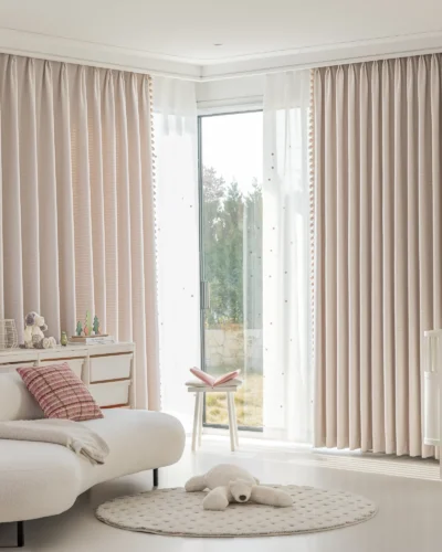 Soft mosaic jacquard curtain in pastel pink hanging in a cozy modern living room