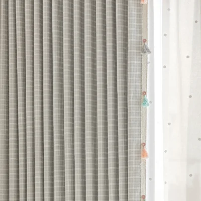 Close-up of Whisper Glow Curtain showing plaid jacquard texture and layered sheer curtain with tassels