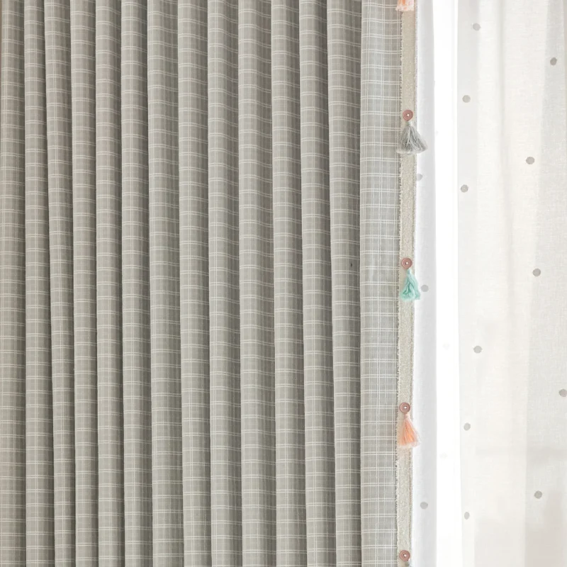 Close-up of Whisper Glow Curtain showing plaid jacquard texture and layered sheer curtain with tassels