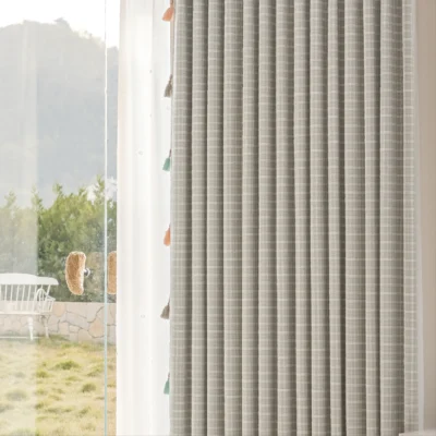 Side view of Whisper Glow Curtain showing plaid jacquard texture and soft daylight filtering near the window