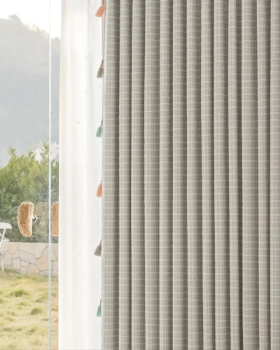 Side view of Whisper Glow Curtain showing plaid jacquard texture and soft daylight filtering near the window