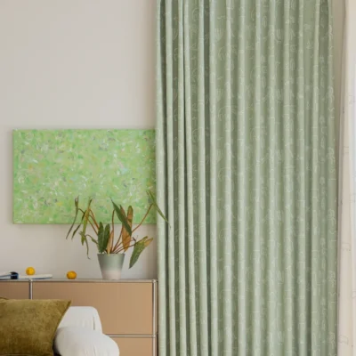 Forest Dream Curtain in green animal jacquard fabric – close-up view in a softly lit kids room with botanical wall art
