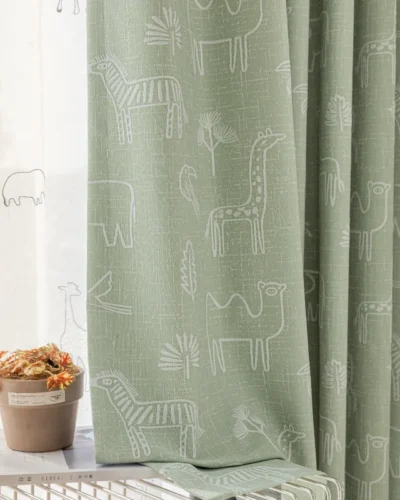 Close-up of Forest Dream Curtain in green animal jacquard fabric with giraffe and bear motifs for kids’ rooms