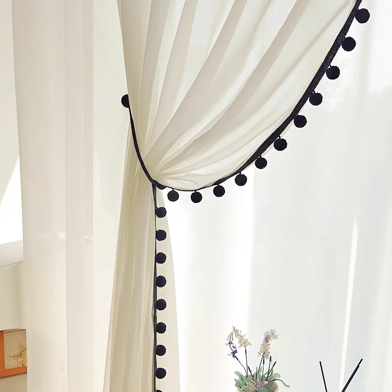 White sheer curtain with soft pom pom trim in black – light and airy interior decor