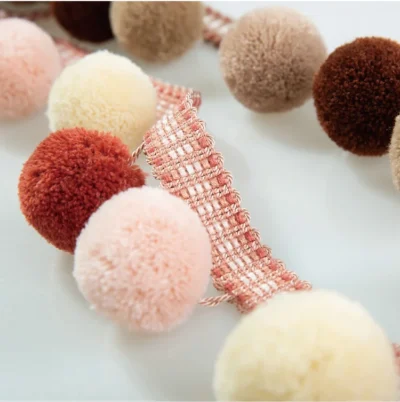 Candy Blush Pom Pom Fringe with soft pink, cream, and red tones – perfect for playful curtain or pillow edging