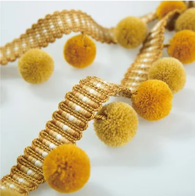 Golden yellow velvet pom pom fringe trim with warm tones and soft texture for curtain or upholstery.