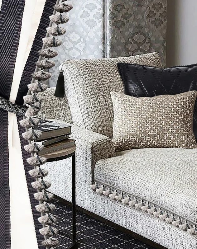 Leather tassel fringe trim used on curtain edge in modern living room with neutral sofa and textured cushions