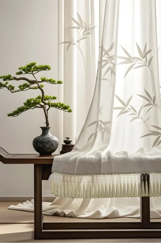 Bamboo tassel curtain fringe softly draping on sheer curtain in a Zen-inspired living space with bonsai