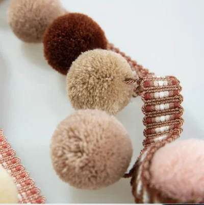 Warm-toned pom pom fringe trim in blush, caramel, and dusty pink — ideal for cozy or vintage interiors
