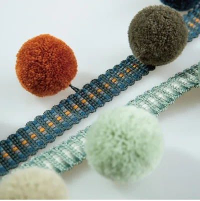 Colorful pom pom fringe with teal-orange trim and multicolor pom poms — adds playful contrast to modern interiors