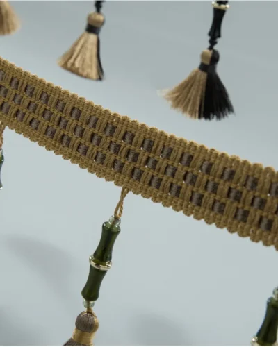Curtain tassel trim with moss green cords and beige tassels in bamboo-style band