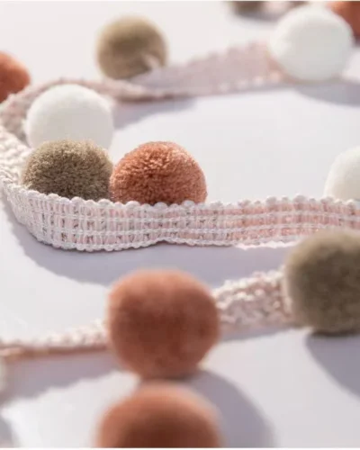 Color swatch of Eden Pom Tassel Trim – assorted pom pom colors in sample display