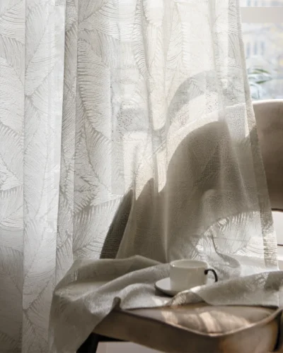 Botanic Veil Curtain draped near a chair, softly diffusing light in a cozy reading nook