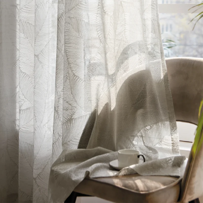 Botanic Veil Curtain draped near a chair, softly diffusing light in a cozy reading nook