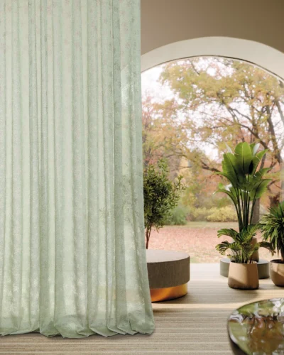 Olive Mist Curtain fully draped in front of a large arched window with soft daylight and botanical sheer texture in a cozy modern interior