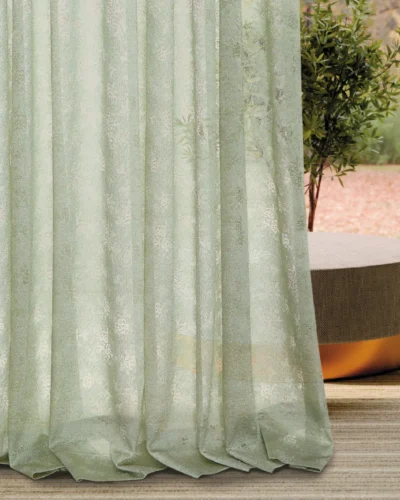 Bottom view of Olive Mist Curtain with soft folds and botanical sheer texture, gently filtering sunlight near a window with greenery outside