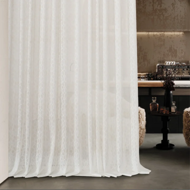 Lightflow lace curtain cascading down in a softly lit transitional room