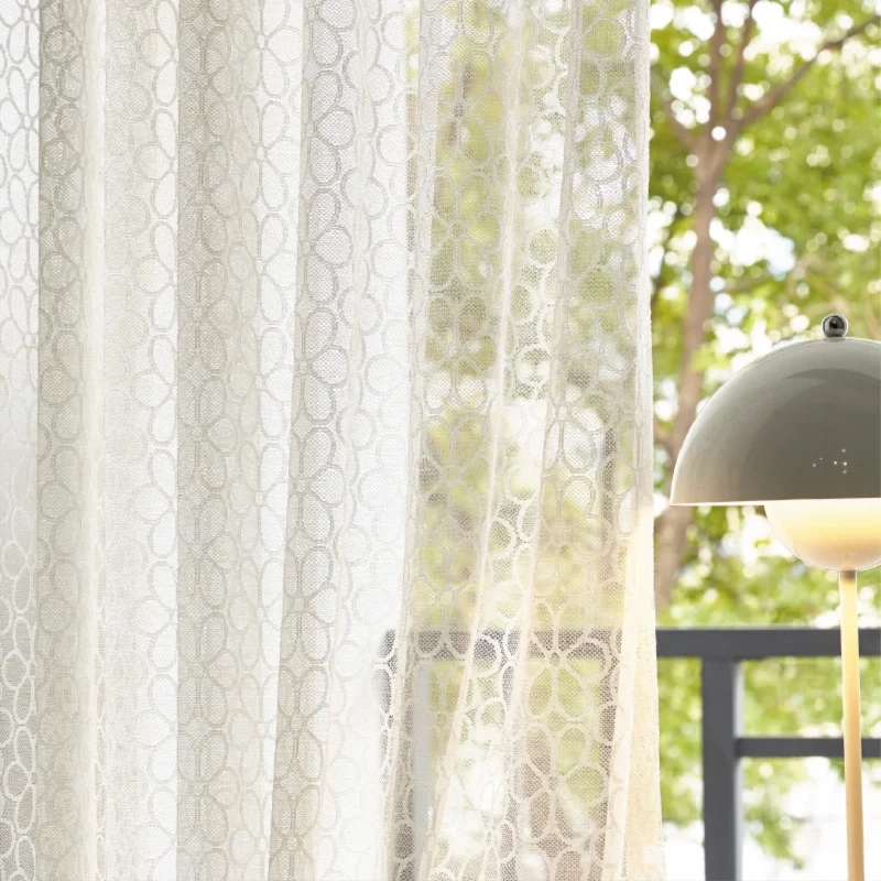 Lightflow lace curtain with elegant geometric patterns by a sunny window