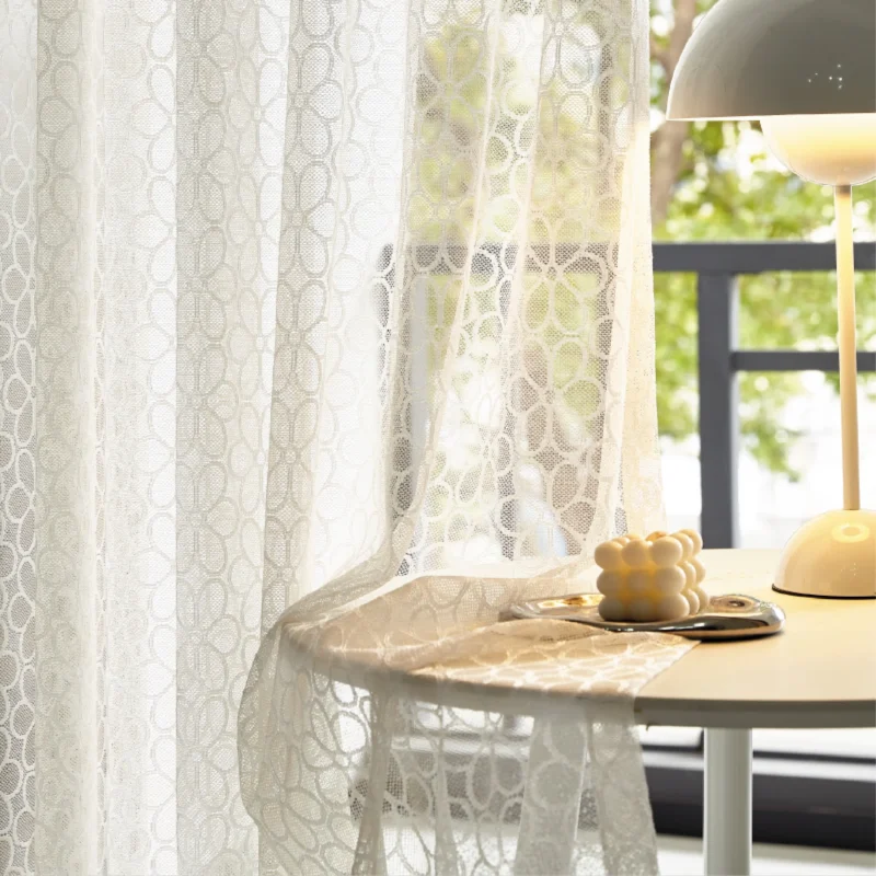 Lightflow lace curtain draped beside a sunny table setup in a serene room