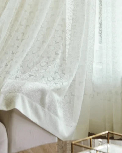 Blossom Veil Sheer Curtain with soft bloom lace draping near a window