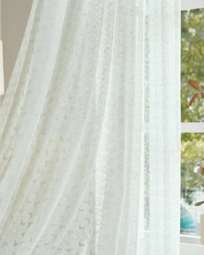 Blossom Veil Sheer Curtain hanging in front of window with soft daylight