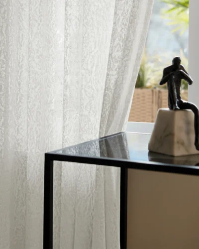 Whisper Texture jacquard sheer curtain with soft daylight and decorative side table