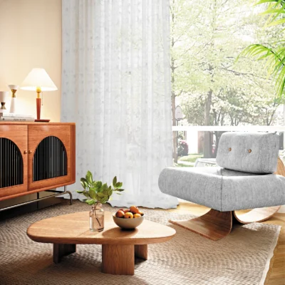 Leaf texture sheer curtain in a modern living room, softly filtering sunlight beside a window with natural scenery