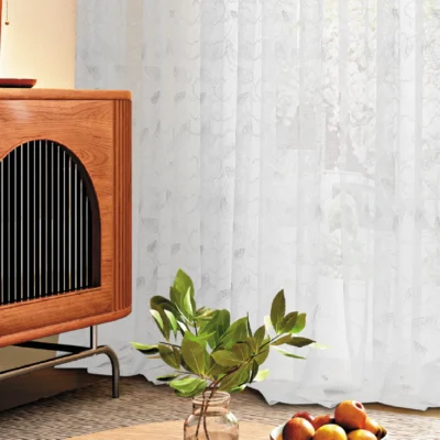Leaf pattern sheer curtain with indoor plant and modern furniture