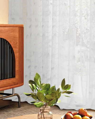 Leaf pattern sheer curtain with indoor plant and modern furniture