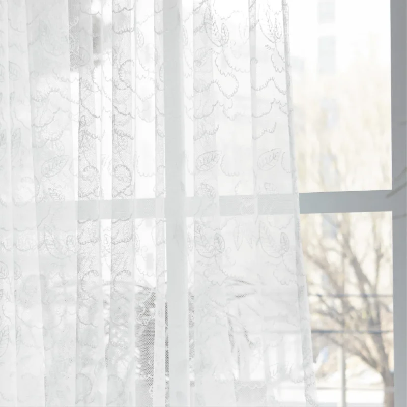 Leaf texture sheer curtain softly filtering light near a window, showing delicate botanical pattern and natural privacy effect