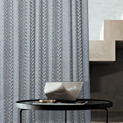 Zigzag sheer curtain hanging beside a staircase and round table