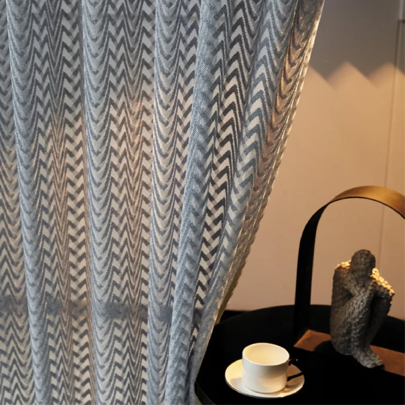 Zigzag sheer curtain with soft sunlight beside a cozy corner