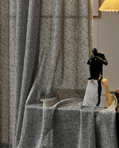 Ripple sheer curtain in modern interior, softly filtering light with elegant wave texture.