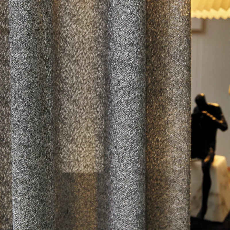 Lightflow lace curtain with subtle ripple texture, styled in a softly lit modern room.