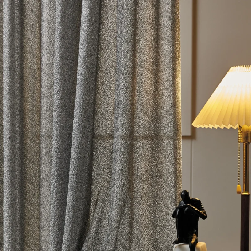 Lightflow lace curtain with textured weave, softly glowing under warm indoor lighting.