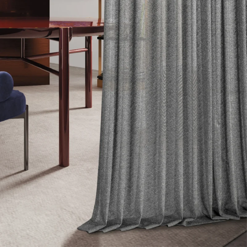 Designer ripple sheer curtain in gray, gently flowing to the floor with textured light filtering.