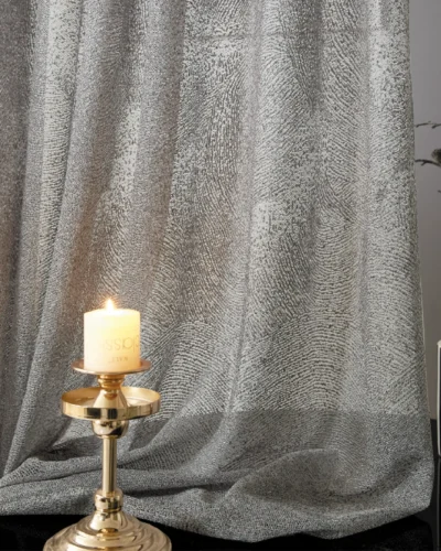 Ripple sheer curtain with subtle wave texture, styled with candlelight for a cozy ambiance.