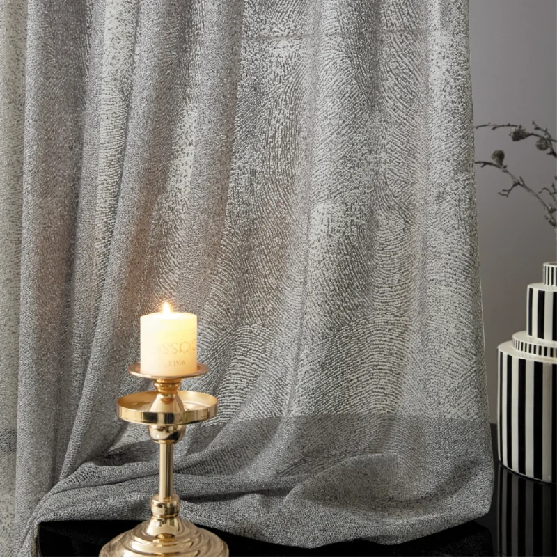 Ripple sheer curtain with subtle wave texture, styled with candlelight for a cozy ambiance.