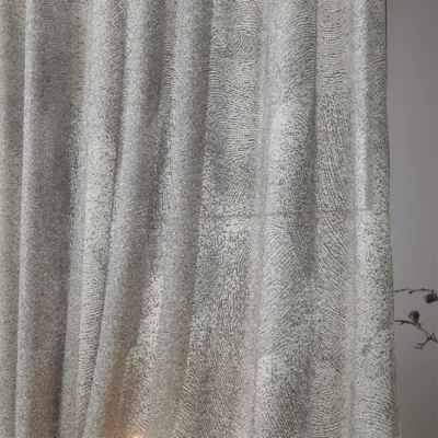 Ripple sheer curtain with subtle wave texture, softly flowing with natural light.
